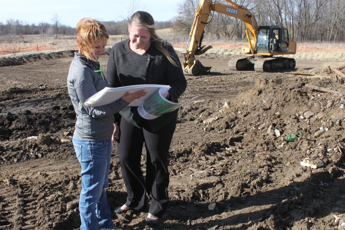 Rodriguez, left, reviews project plans with Weitkemper at one of the cleanup sites of the future 2,300-acre East Locust Creek Reservoir in Sullivan County near Milan, Mo.Photo by Phil Leslie
