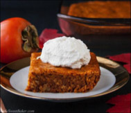 Persimmon pudding topped with whipped cream.