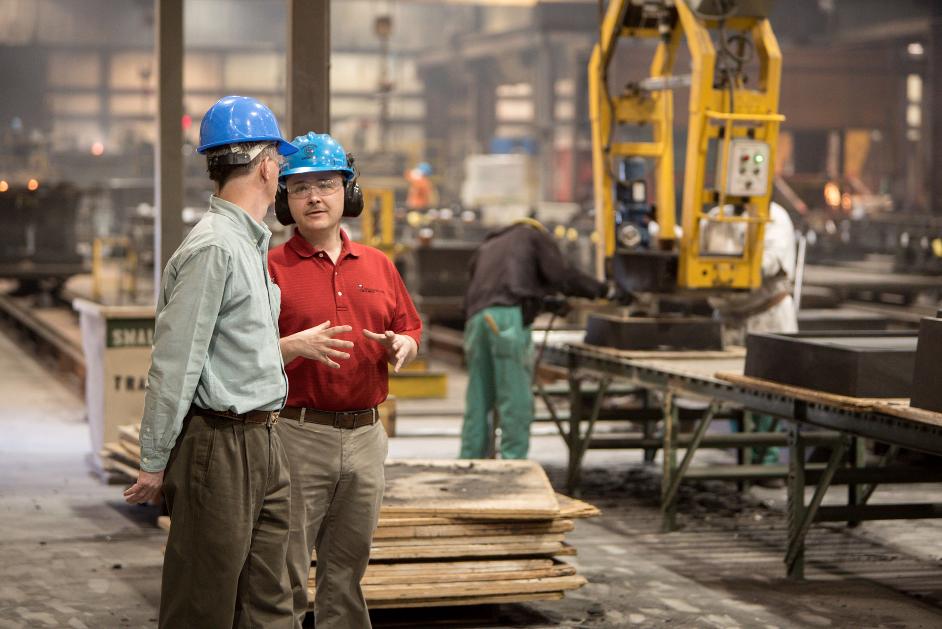 Workers conversing on factory floor