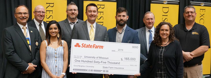 Group of MU Fire and Rescue Training Institute personnel accepting grant from State Farm