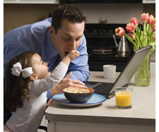 Small girl feeding cereal to her dad