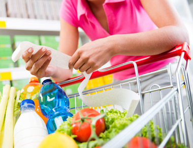 Woman grocery shopping with list