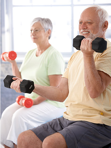 Senior couple lifting dumbbells