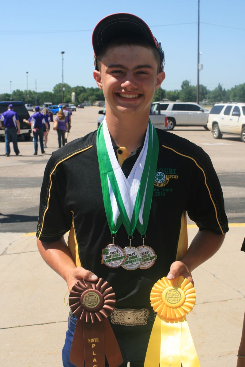 Member shows off medals and ribbons from the National 4-H shooting sports competition