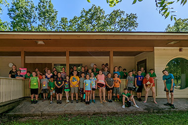 Campers in front of cabin