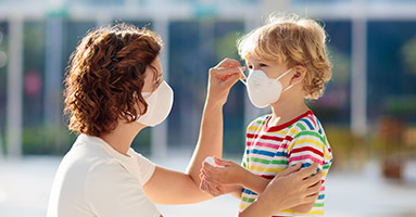 Mother and child wearing protective face masks
