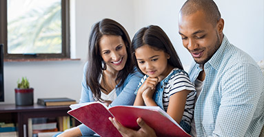 Parents with young child reading together