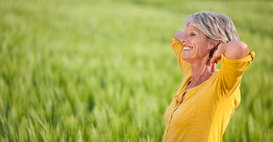 Smiling woman standing in field