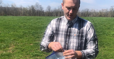 MU Extension agronomist Gatlin Bunton demonstrates how to take a soil sample