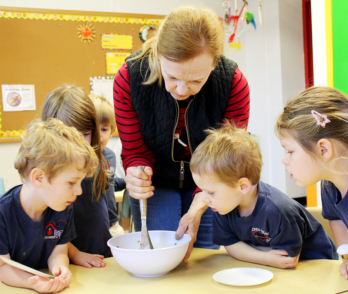Students at Sacred Heart Villa Preschool on The Hill in St. Louis learn how to make 'smashy peas' from chef and Master Gardener Margaret Grant. Photo by Linda Geist.