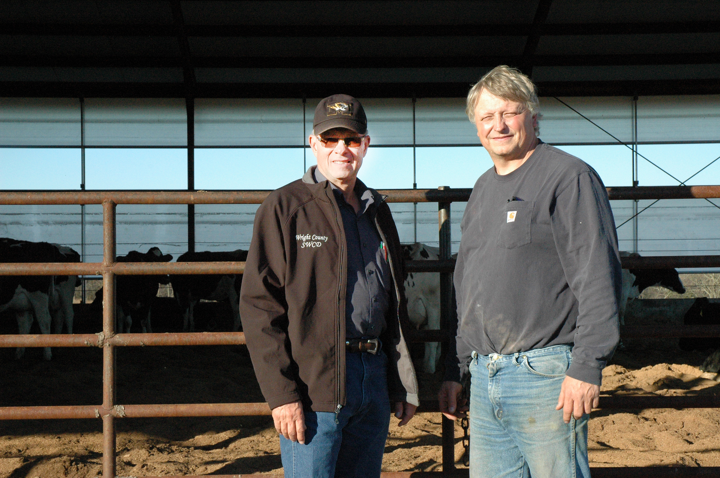 University of Missouri Extension specialist Ted Probert, left, says compost-bedded pack barns provide many benefits for dairy cows. Dwight Fry, right, says one of the benefits has been reduced somatic cell counts, an indicator of higher milk quality.