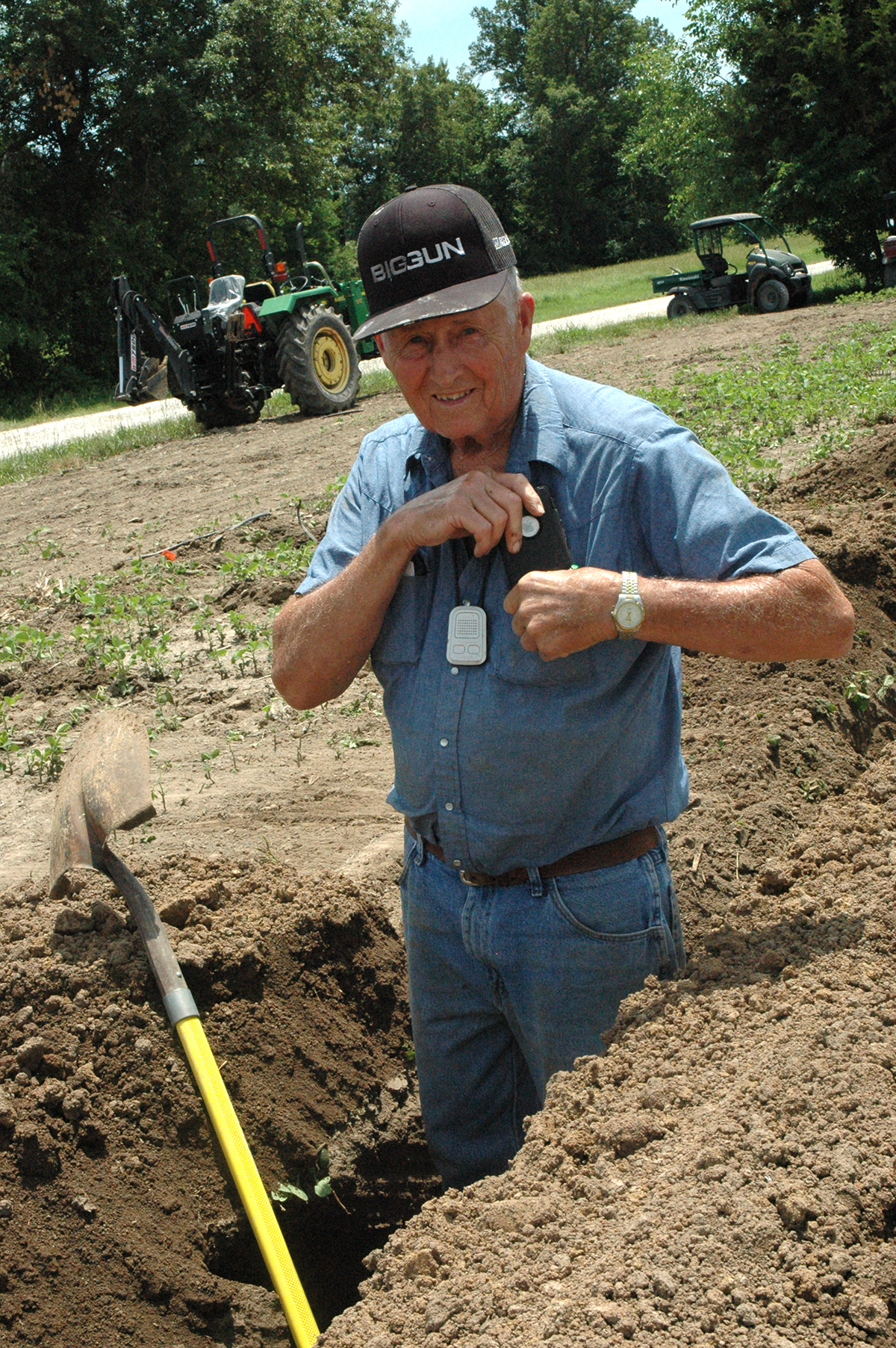Open Bellflower, Mo., farmer Russel Winter uses his phone to track weather and the markets while helping trench a ditch for subsurface drip irrigation. Photo by Linda Geist.