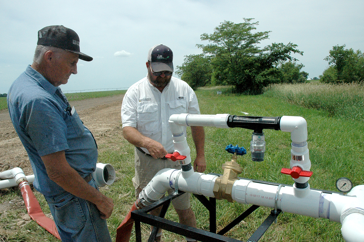 Russel Winter, left, and MU Extension agronomist Rusty Lee, right, use subsurface drip irrigation (SDI) at their farms. They built their own trenchers for the drip lines, and Winter helped design the water pump and filtration unit for his SDI system. Phot