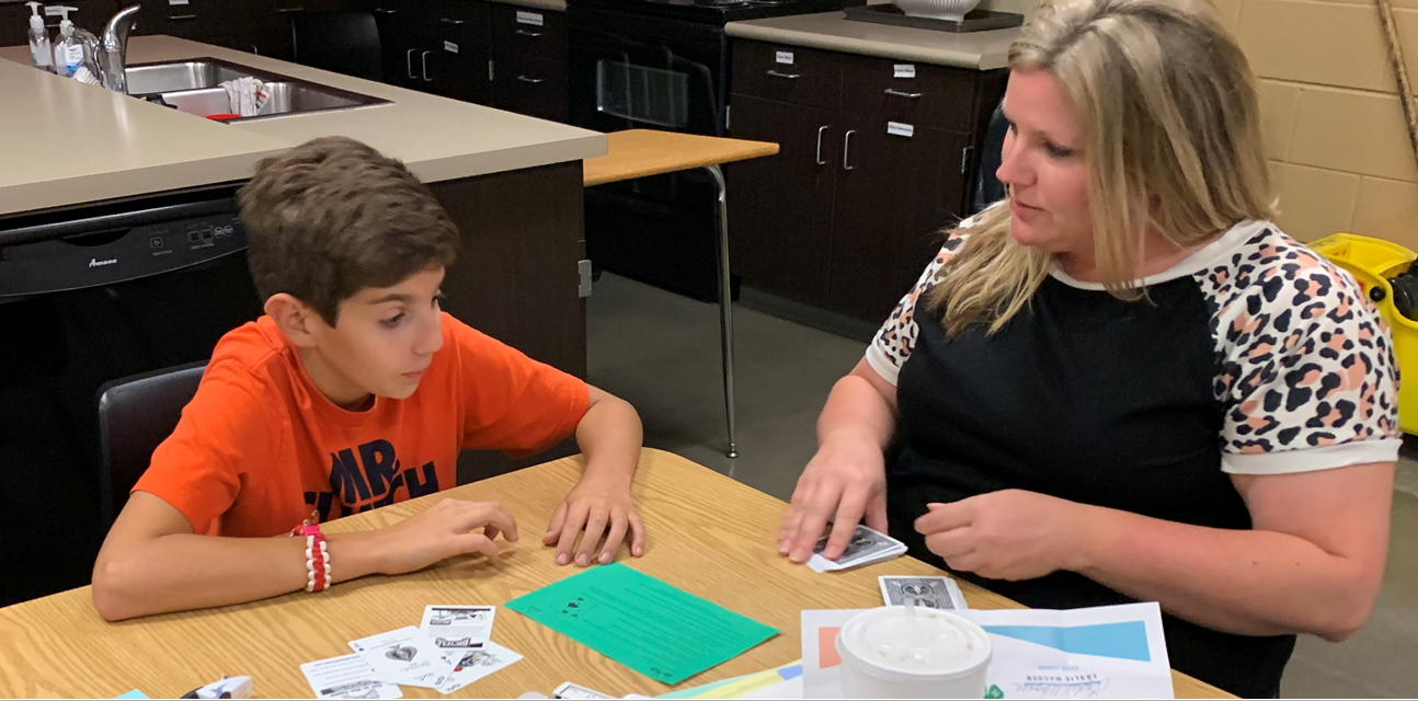 Open Sarah Garcia and her son Greyson participate in a Strengthening Families activity to improve communication.