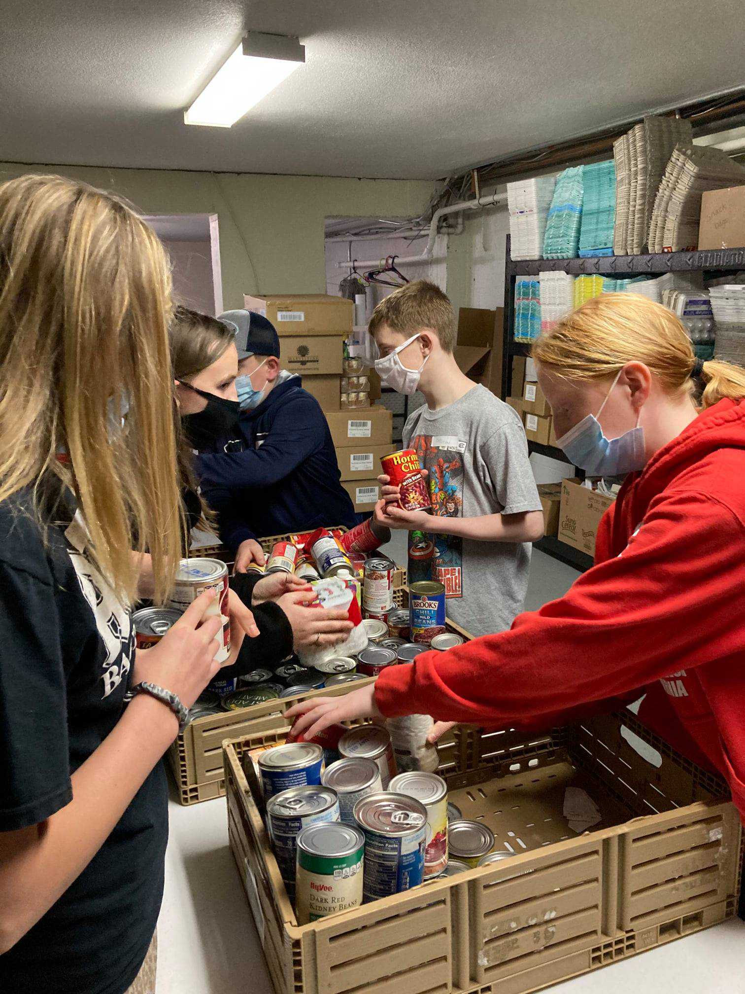 Cass County 4-H'ers, seen here helping at the Shepherd’s Staff Food Pantry in Harrisonville, Mo., raised the equivalent of more than 53,000 meals during the 2021 4-H Feeding Missouri food drive.