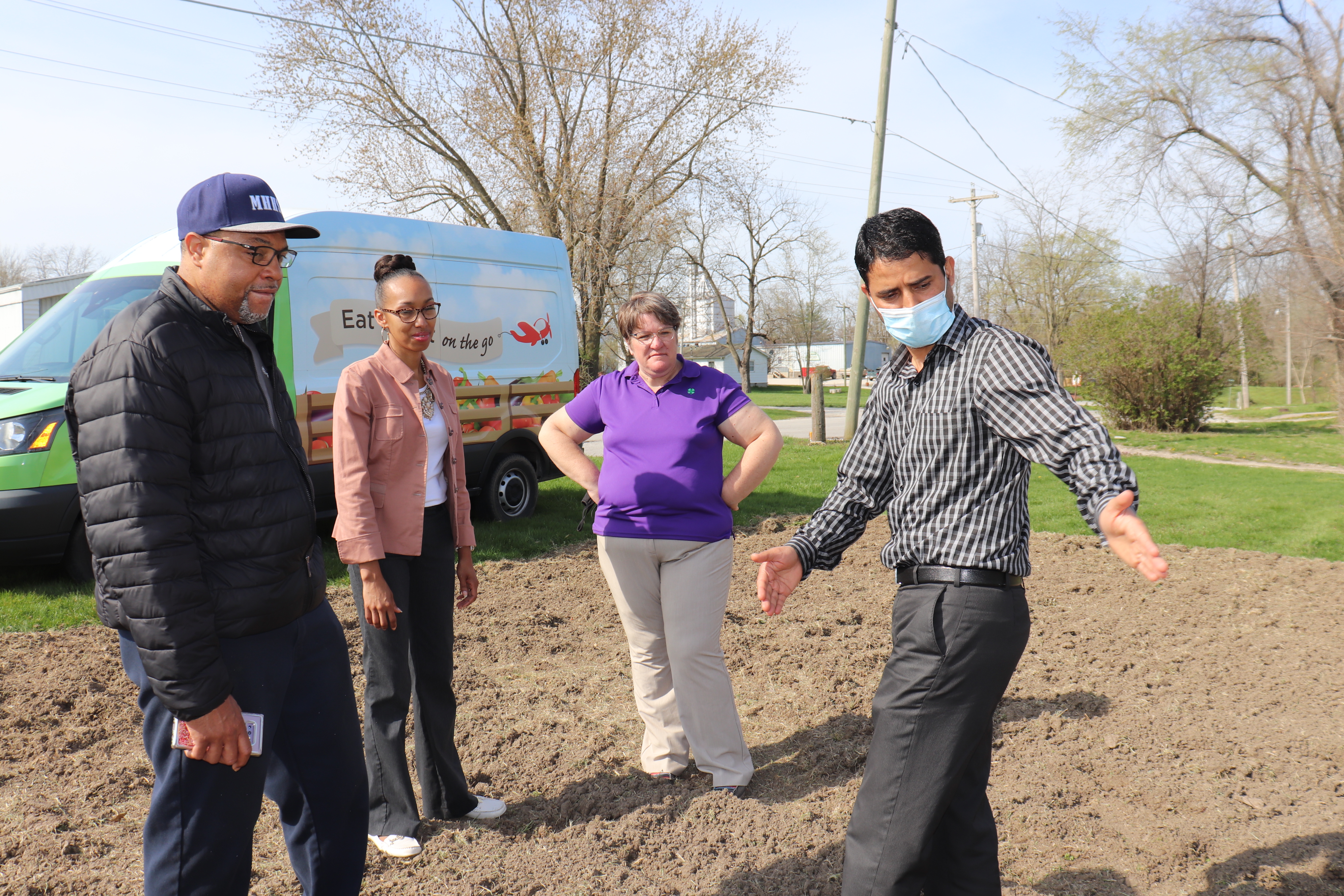 MU Extension agronomist Dhruba Dhakal, right, explains how the community garden at Faith Walk Academy should be plotted. Looking on are Michael and Mya McClain and MU Extension youth program associate Kathy Hasekamp. Photo by Linda Geist.