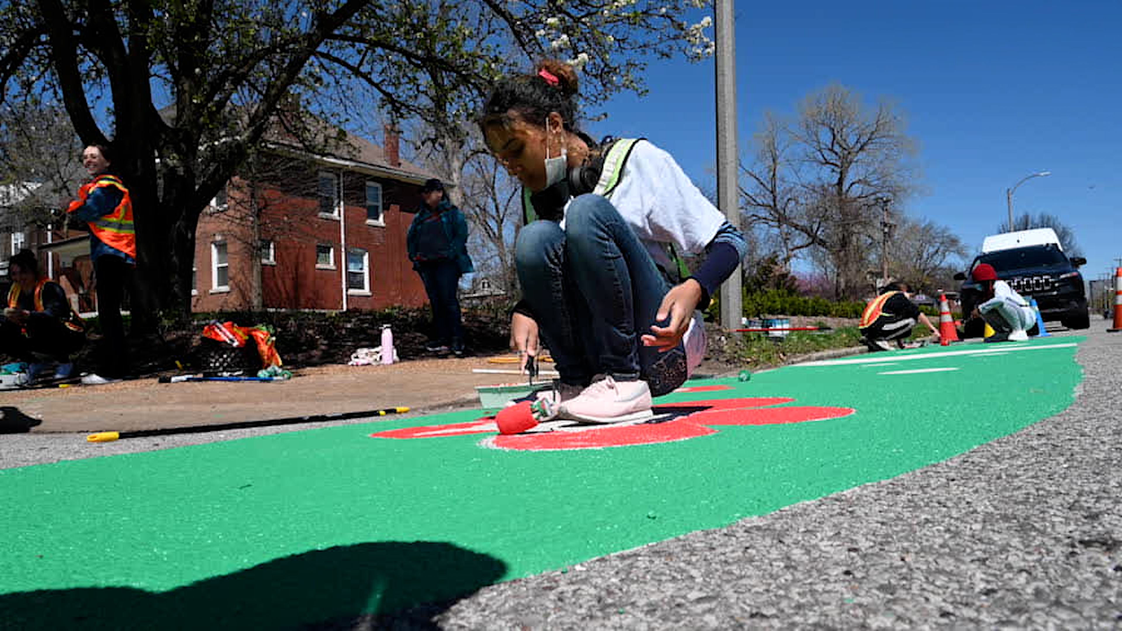 Open St. Louis ArtWorks youths, with help from Washington University graduate students, created colorful designs to paint on four Hamilton Avenue intersections.