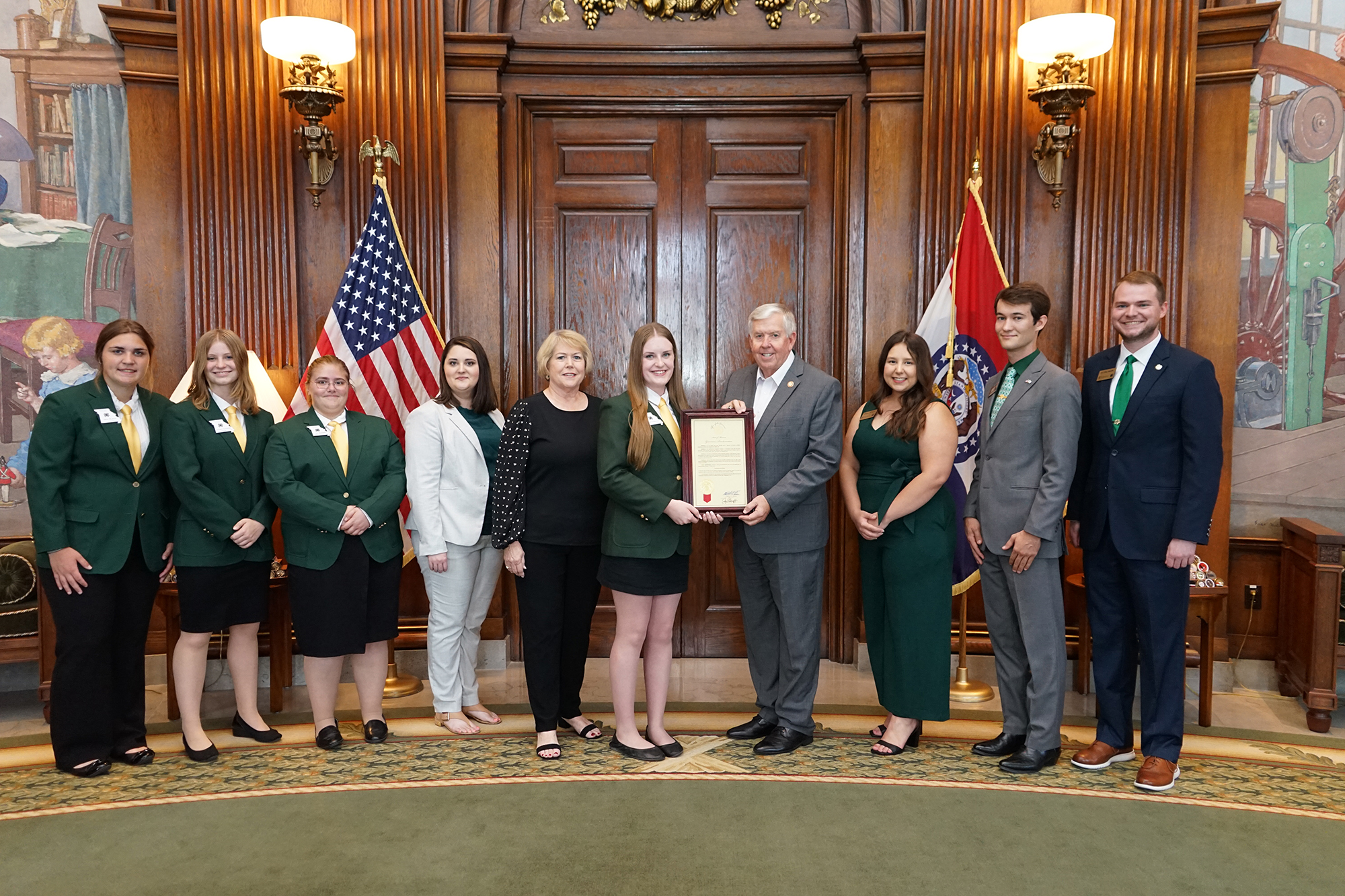 Missouri Gov. Mike Parson, fourth from right, presents a proclamation designating Oct. 1-7, 2023, as National 4-H Week in Missouri. Pictured, from left, State 4-H Council members Taylor Muench, Emmalyn Schnieders and Lily Rucker, adviser Juli Thrasher, Mi