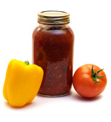 Jar of salsa, one tomato and one yellow pepper