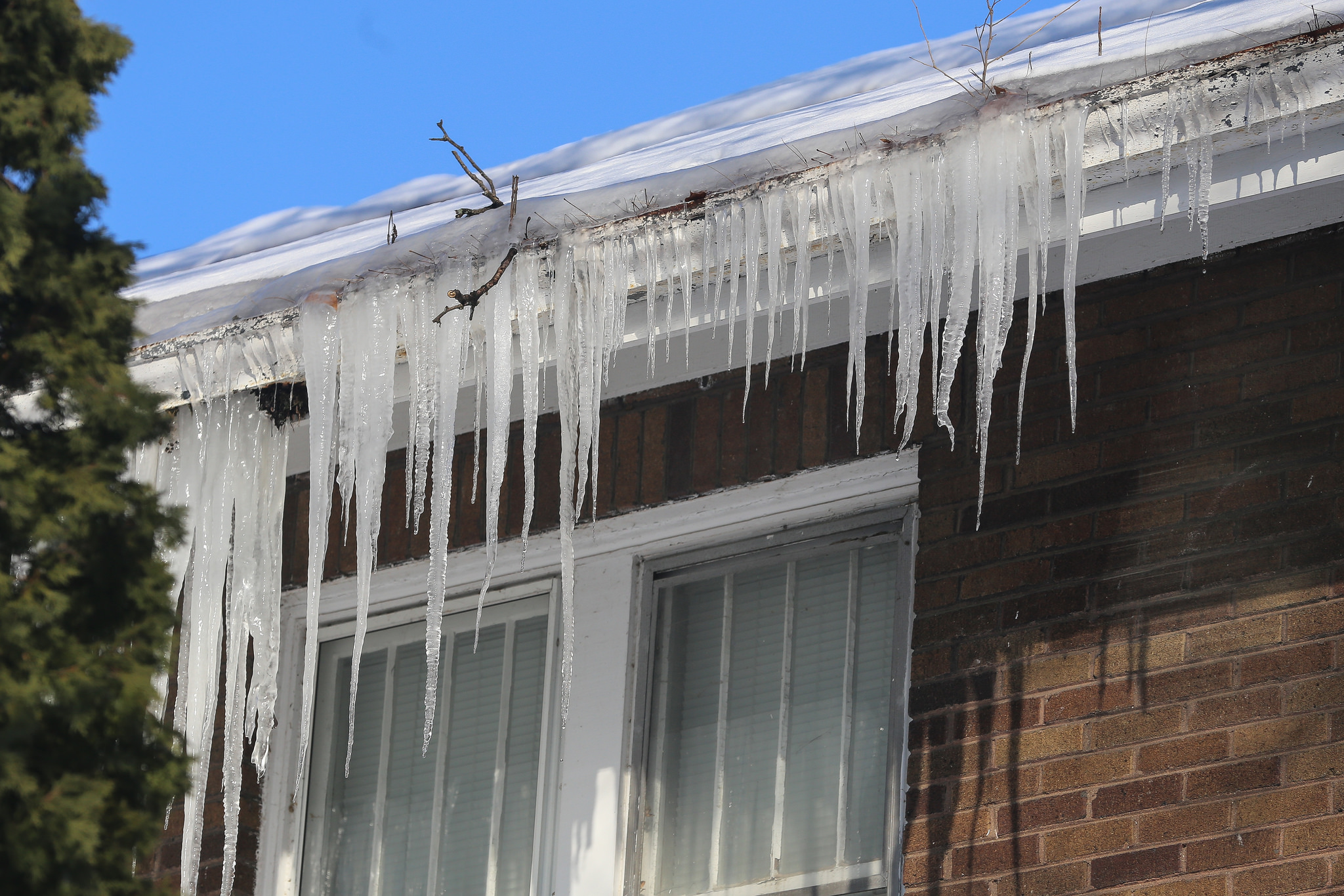 Open Freezing snowmelt can build up and form a dam of ice, behind which water pools up into large puddles or “ponds.” The ponding water can then back up under the roof covering and leak into the attic or along exterior walls.