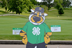 Truman the Tiger cutout wearing a 4-H shirt at a golf course