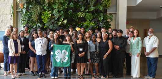 group of 4-Hers with a banner