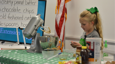 a girl presenting with a stand mixer