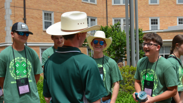 group of youth in 4-H shirts chatting