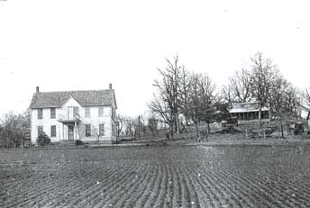 Old photo of farmhouse and field