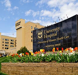front of MU Hospital with flowers and sign