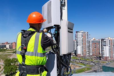 Telecommunication engineer with equipment working on pole