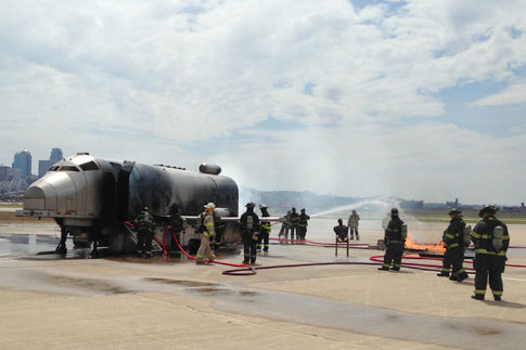 Firefighters extinguishing an aircraft fire on the tarmac