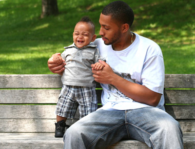 Father with young son on park bench