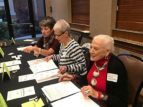 Osher volunteers work a registration table at an event.