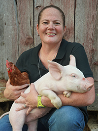 Heather Conrow with pig and chicken