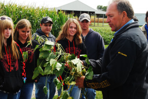 instructor shows plants to students