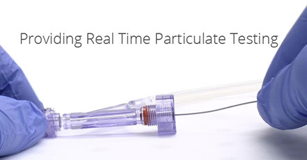 Gloved hands performing particulate testing. Image property of Dynatek Labs. Used with permission.
