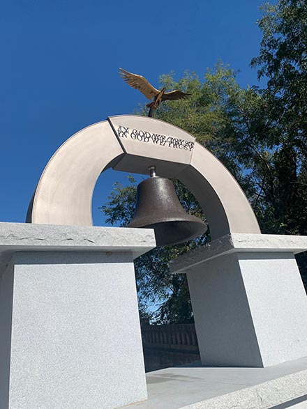 Veterans Memorial with arch and eagle on top and bell from the Hannibal battleship pre-World War 1. Photo property of Hannibal Machine. Used with permission.