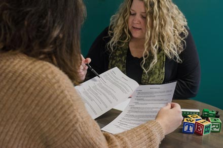 Anita Archer reviewing paperwork with a client.