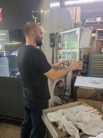 A man programming a CNC.