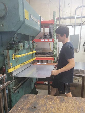 A man doing press brake fabrication.