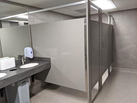 A public bathroom with stalls.