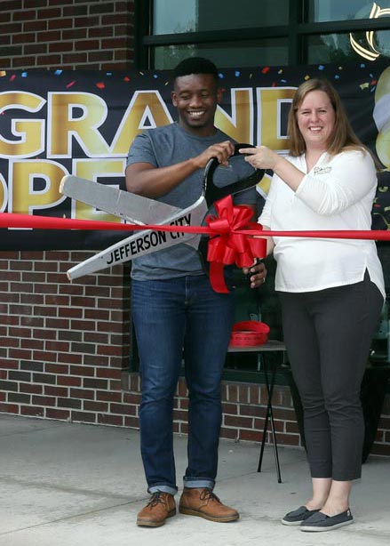 Elo and Dara Osoego cutting a ribbon at the clinic's grand opening.
