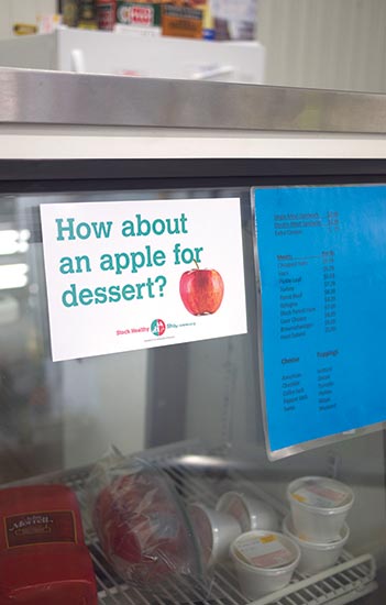 Sign with red apple that reads "How about an apple for dessert?"