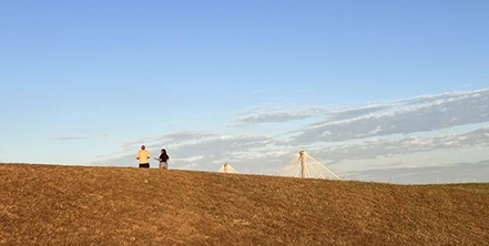 A group of people on a hill at Lincoln-Shields Recreation Area, West Alton, St. Charles County Missouri - Clark Bridge in the background.