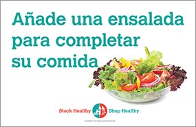 Sign with colorful salad that reads "Añade una ensalada para completar su comida" (add a salad for a complete meal).
