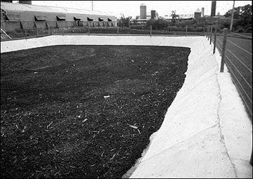 Concrete-lined earthen pit