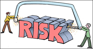 Two people on different sides of the word risk sawing the word in half from the top.