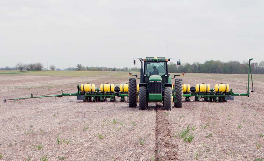 A row crop planter in a field.