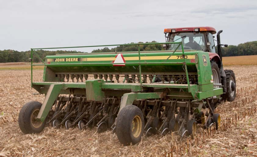 A no-till box drill in a field.